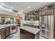 Modern kitchen with stainless appliances, granite counters and a center island at 12738 W Brookhart Way, Peoria, AZ 85383