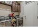 Functional laundry room with stainless steel appliances, overhead cabinets, and ample storage space at 12738 W Brookhart Way, Peoria, AZ 85383
