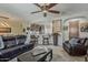 Spacious living room with open floor plan, leather furniture, and tile flooring at 12738 W Brookhart Way, Peoria, AZ 85383
