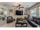 Spacious living room with leather furniture, tile flooring, and ceiling fan at 12738 W Brookhart Way, Peoria, AZ 85383