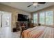 Well-lit main bedroom features a TV, shuttered windows, tile flooring, and neutral color palette at 12738 W Brookhart Way, Peoria, AZ 85383