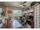 Well-lit home office with a large window, comfortable executive chair, and custom built-in shelving at 12738 W Brookhart Way, Peoria, AZ 85383