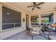 Covered patio with wicker furniture, outdoor seating, and views of the landscaped backyard, creating a relaxing retreat at 12738 W Brookhart Way, Peoria, AZ 85383