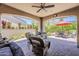 Inviting covered patio with comfortable seating, an outdoor grill, and views of the landscaped backyard at 12738 W Brookhart Way, Peoria, AZ 85383