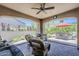 Relaxing covered patio with outdoor seating, ceiling fan, and views of the beautifully landscaped backyard and patio at 12738 W Brookhart Way, Peoria, AZ 85383