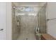 Glass-enclosed shower with tile surround, built-in bench, and multiple shower heads for a luxurious experience at 12738 W Brookhart Way, Peoria, AZ 85383
