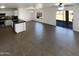 Open-concept kitchen with granite countertops, stainless steel appliances and tile flooring at 12801 N El Frio St, El Mirage, AZ 85335
