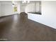 Open-concept living area with stylish tile flooring, a kitchen bar, and abundant natural light at 12801 N El Frio St, El Mirage, AZ 85335