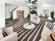 Bright, open living area featuring modern decor and an adjacent dining space with a ceiling fan for maximum comfort at 12801 N El Frio St, El Mirage, AZ 85335