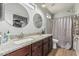 Bathroom featuring dual sinks, dark wood cabinetry, and a shower with a curtain at 1350 S Greenfield Rd # 2159, Mesa, AZ 85206