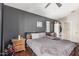 Bedroom with ceiling fan, dark wood flooring, and a gray accent wall at 1350 S Greenfield Rd # 2159, Mesa, AZ 85206
