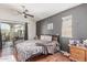 Bedroom featuring wood floors, ceiling fan, and sliding glass doors to a patio at 1350 S Greenfield Rd # 2159, Mesa, AZ 85206