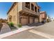 Lovely townhome exterior featuring a three-car garage and second-story balcony at 1350 S Greenfield Rd # 2159, Mesa, AZ 85206