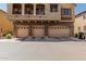Attached three-car garage, stone detailing, and second story balcony at 1350 S Greenfield Rd # 2159, Mesa, AZ 85206