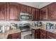 Spacious kitchen with stainless steel appliances and dark wood cabinetry at 1350 S Greenfield Rd # 2159, Mesa, AZ 85206