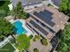 Aerial view of home with solar panels, pool, trampoline, patio, and lush landscaping at 13633 W Alvarado Dr, Goodyear, AZ 85395
