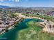 Stunning aerial view of golf course homes with lake and mountain views at 13633 W Alvarado Dr, Goodyear, AZ 85395