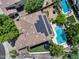 Overhead view of a home with solar panels, backyard trampoline, pool, and manicured lawn at 13633 W Alvarado Dr, Goodyear, AZ 85395