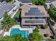 Aerial view of a home featuring a pool, solar panels, a trampoline, and a meticulously landscaped yard at 13633 W Alvarado Dr, Goodyear, AZ 85395