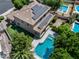 Aerial view of backyard with a pool, lush green landscaping, and a patio with flowering bushes at 13633 W Alvarado Dr, Goodyear, AZ 85395
