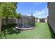Spacious backyard featuring a trampoline and artificial turf for Gathering fun and recreation at 13633 W Alvarado Dr, Goodyear, AZ 85395