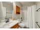 Bathroom with vanity, commode and shower-tub combination with curtain at 13633 W Alvarado Dr, Goodyear, AZ 85395