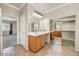 Bathroom featuring double vanities, tile floors, and mirror sliding closet doors at 13633 W Alvarado Dr, Goodyear, AZ 85395