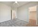 Neutral bedroom featuring plush carpet, ceiling fan, and a convenient walk-in closet at 13633 W Alvarado Dr, Goodyear, AZ 85395