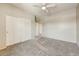 A bright, spacious bedroom features sliding door closets, carpet, and neutral walls at 13633 W Alvarado Dr, Goodyear, AZ 85395