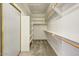 Walk-in closet featuring carpet, built-in shelving, and clothes rods at 13633 W Alvarado Dr, Goodyear, AZ 85395