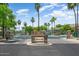 Welcoming community entrance with stone pillars, lush landscaping, and security gate at 13633 W Alvarado Dr, Goodyear, AZ 85395