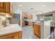Well-lit kitchen features stainless steel appliances, tiled flooring, wooden cabinets and a view of the backyard at 13633 W Alvarado Dr, Goodyear, AZ 85395