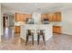 Well-equipped kitchen featuring light wood cabinets, counter seating, and stainless steel appliances at 13633 W Alvarado Dr, Goodyear, AZ 85395