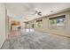 Spacious living room with tiled and carpeted flooring, ceiling fans and backyard access at 13633 W Alvarado Dr, Goodyear, AZ 85395