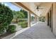 A covered patio is furnished with ceiling fans and overlooks a lush backyard with desert landscaping at 13633 W Alvarado Dr, Goodyear, AZ 85395