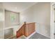 Carpeted staircase with a natural wood railing and landing area with window at 13633 W Alvarado Dr, Goodyear, AZ 85395