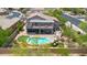 Drone shot showcasing the home's landscaped backyard with a sparkling pool, covered patio, and lush greenery at 1365 N Drexel St, Mesa, AZ 85207