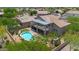 A home with a pool, covered patios, synthetic grass and lush desert landscaping creating an outdoor oasis at 1365 N Drexel St, Mesa, AZ 85207