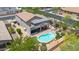 Captivating aerial view of a home with a private backyard oasis including a sparkling pool and covered patio area at 1365 N Drexel St, Mesa, AZ 85207
