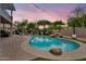 Inviting backyard with a pool, a stone waterfall, and string lights creating a relaxing ambiance at 1365 N Drexel St, Mesa, AZ 85207