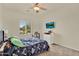 Bedroom featuring a large window, ample closet space, dresser, and modern wall-mounted TV at 1365 N Drexel St, Mesa, AZ 85207