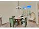 Bright dining room featuring green chairs, modern chandelier, and natural light at 1365 N Drexel St, Mesa, AZ 85207
