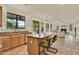 Open-concept kitchen flowing into the living room, featuring bar seating, and views of the cozy living room at 1365 N Drexel St, Mesa, AZ 85207