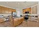 Kitchen with island, stainless steel appliances, granite counters and natural wood cabinets at 1365 N Drexel St, Mesa, AZ 85207