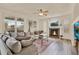 Spacious living room featuring a fireplace, ceiling fan, and large windows with shutters at 1365 N Drexel St, Mesa, AZ 85207
