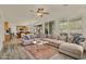 Open living space featuring a large sectional couch, ceiling fan, and access to a kitchen at 1365 N Drexel St, Mesa, AZ 85207