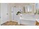 Main bathroom with soaking tub, a separate glass shower and plantation shutters at 1365 N Drexel St, Mesa, AZ 85207