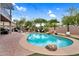 Backyard oasis with a sparkling pool, rock waterfall feature, and outdoor seating for ultimate relaxation at 1365 N Drexel St, Mesa, AZ 85207