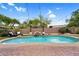 Relaxing outdoor pool area with a stone waterfall, seating, and lush turf, ideal for leisure at 1365 N Drexel St, Mesa, AZ 85207