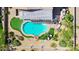 An aerial view showcases a tranquil swimming pool, pristine landscaping, and comfortable lounging spots at 1365 N Drexel St, Mesa, AZ 85207